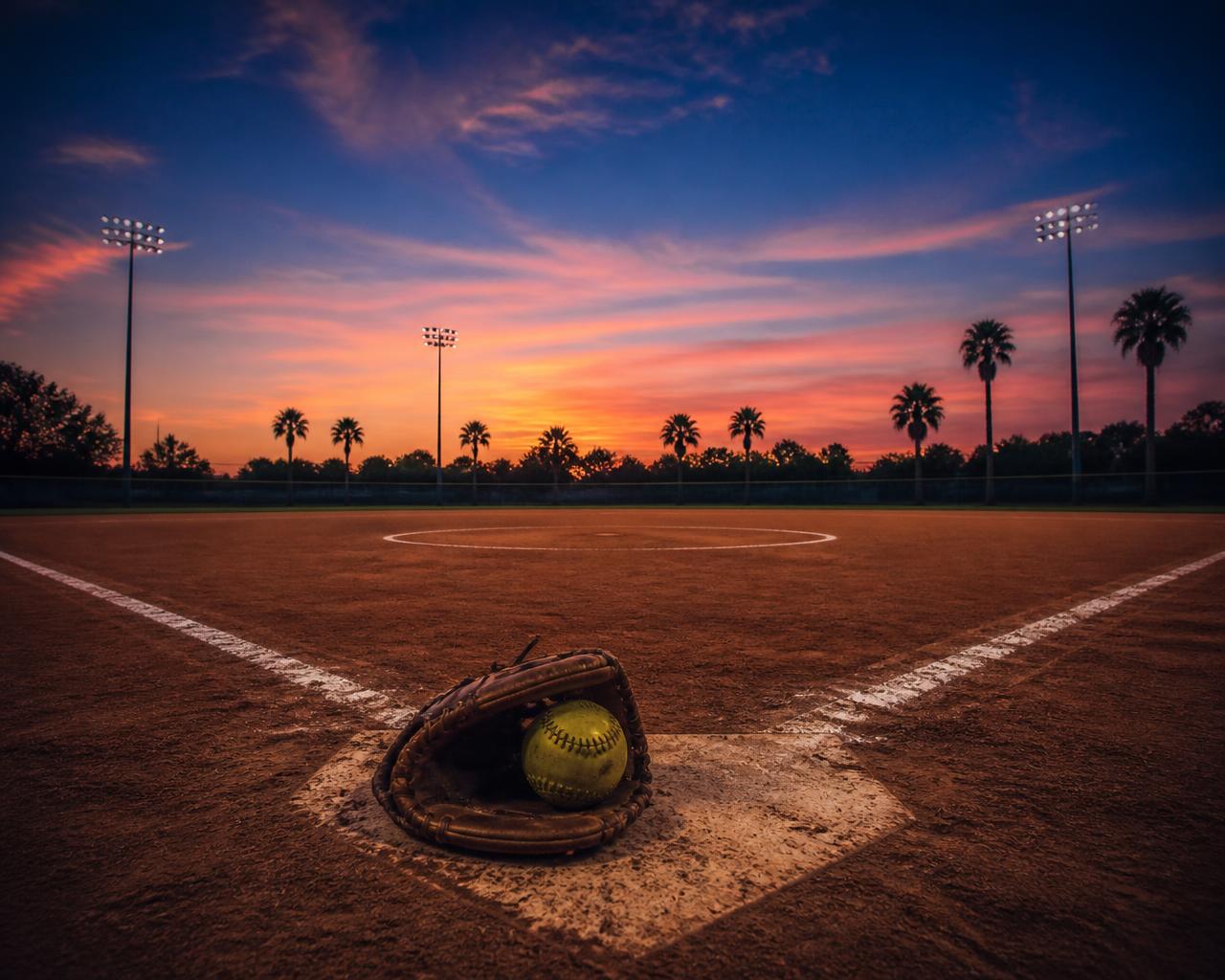 Sarasota softball field at sunset with a glove and softball on home plate